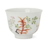 A Chinese porcelain tea bowl, 19th century, finely painted in famille rose enamels with floral