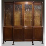 A mahogany breakfront bookcase, early 19th Century, the moulded cornice above four Gothic arch