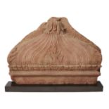 A red sandstone fragment of a dome, Mughal India, 17th century, carved with a lotus flower to top,