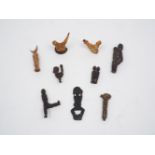 A collection of tribal interest small wood and bone carvings, early 20th century and later, of