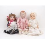 A collection of dolls, 20th century and later, to include: a collectors baby doll, dressed in a pink