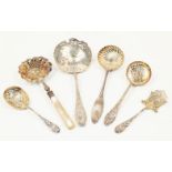A group of six French silver straining spoons and servers, various designs and makers including a