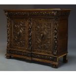 A late Victorian carved oak cabinet, the rectangular top above scrolling foliate carved frieze