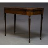 A Regency mahogany and boxwood strung tea table, the fold over top, on reeded and tapering