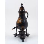 A tin samovar on tripod feet with cover, handle and spout, with gilt decorative features to the