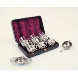 A cased set of late Victorian silver cup holders with glass inserts, London, c.1890, William Comyns,