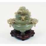A jadeite carved censer and cover, with dragon form finial and three ringlets to the cover, and