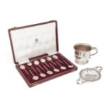 A silver tea strainer, London, c.1958, William Comyns & Sons., with stylised scroll handles and
