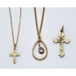 A group of three necklaces comprising: a cross pendant necklace, stamped 14k, pendant length (inc.