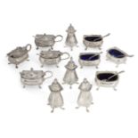 A matched set of silver cruets, comprising four each peppers, salts and mustard pots, various