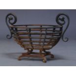 A cast iron fire basket, early 20th century, of oval pierced form, with curled twin loop handles,