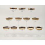 A set of twelve modern champagne glasses, the bowls of circular tapering form, to a plain polished