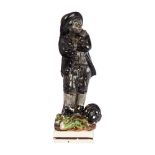 A Staffordshire pearlware figure of a chimney sweep, early 19th century, with a sack of soot and a