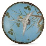 A Japanese cloisonné dish, early 20th century, decorated with a crane in flight amongst floral