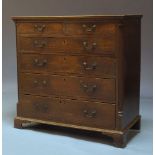 A George III oak chest of drawers, with two short over four long graduated drawers, flanked by