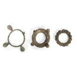 Three large Chinese bronze bracelets, Neolithic period, each cast with spherical knops, 9cm - 16cm
