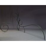 A pair of wrought iron and green painted garden sculptures, comprised of curved and scrolling iron