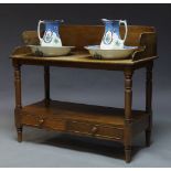 A Victorian mahogany washstand, the top with raised back and sides, the top surface with two