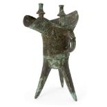 A Chinese archaic bronze ritual wine vessel, jue, Shang dynasty-style, the deep U-shaped body raised