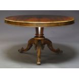 A Victorian rosewood tilt top breakfast table, the circular top on tapered column support to foliate