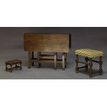 A George III oak gate leg table, with two drop leaves, with frieze drawer to one end, raised on