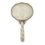 A Chinese greenish-white jade plaque and belt hook, 18th century, now mounted to form a hand mirror,