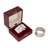 A silver napkin ring in fitted case, London, c.1973, CJ Vander Ltd., of plain flattened oval form,
