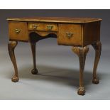 A George II style walnut lowboy, early to mid 20th Century, the rectangular quarter veneered top,