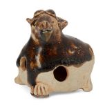 A Chinese pottery whistle in the form of a goat, Tang dynasty, in recumbent pose with four short