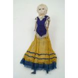 A Victorian wax 'pumpkin-head' doll, circa. 1840, with moulded blonde hair, set with brown glass