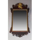 A George III style mahogany fretwork mirror, early 20th Century, the crest with carved gilt Ho Ho