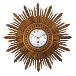 A carved gilded wood sunburst clock, late 20th century, with convex glass cover, enamel dial and