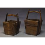 A pair of Chinese hardwood rice buckets, of rectangular form with arching handle and metal bosses,