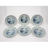 A group of six Chinese porcelain dishes, 18th century, of blue and white ground with central