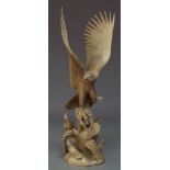 A pair of modern carved wood sculptures, designed as a landing eagle to awaiting fledglings all atop