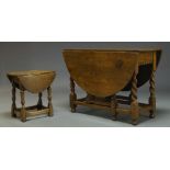 An oak gateleg table, early 20th Century, the oval top, with two drop leaves, above single frieze