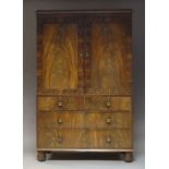 A Victorian flame mahogany linen press, the moulded cornice above two panelled doors, enclosing four