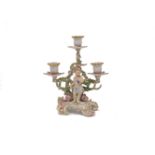 A Berlin porcelain three branch table candelabra, late 19th century, decorated in the Meissen style,