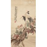 A Chinese silk embroidered hanging scroll, 19th century, decorated with two red-crested cranes,