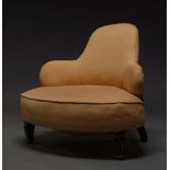 A Victorian nursing chair, with shaped back, upholstered in salmon pink material, raised on ebonised