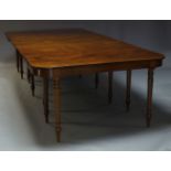 A George IV mahogany extending dining table, with two D-ends flanking central drop leaf section,