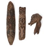 A Pacific Island carved wood plague/mask, possibly Polynesian, 83cm long, a further example,