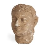A Gandhara stucco head of a Buddha, Afghanistan, 3-4th century, with bow-shaped mouth and heavy-