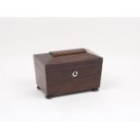 A mahogany two-section tea caddy, 19th century, of tapering sarcophagus form on four spreading feet,