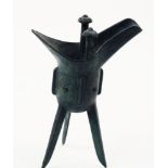 A Chinese bronze archaistic wine vessel, jue, Shang dynasty-style, the deep U-shaped body raised