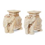 A pair of ceramic elephant form jardiniere stands, of cream ground with orange border highlights and