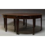 A Regency mahogany and crossbanded extending D-end dining table with two additional leaves on