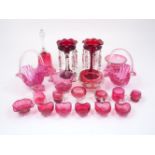 A quantity of cranberry glass pieces, 20th Century, to include five heart shaped cups, a pair of