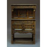 A 17th Century style dwarf oak court cupboard, early 20th Century, with overall carved decoration,