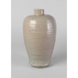 A Chinese grey stoneware ribbed vase, Song/Yuan, with thick pale celadon glaze, glazed base, 22.